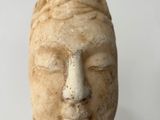 sculpture of a woman ' s face on a white background