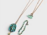 three necklaces with turquoise and green beads on a white background
