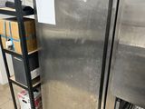 a refrigerator that is in the middle of a kitchen