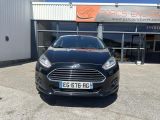 the front of a black ford fiesta parked in front of a building
