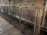 many metal beds lined up in a row in a building