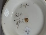 a white plate with writing on it with a sticker on it