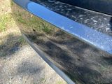 a black car parked on the side of the road