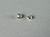 a pair of diamond stud earrings sitting on top of a white surface