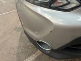 a close up of a car ' s front bumper with a denting on it