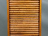 an old wooden cabinet with a drawer on top of it