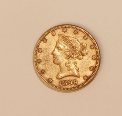 a close up of a gold coin with a woman ' s head on it