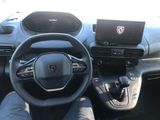 the interior of a car with a laptop on the dashboard
