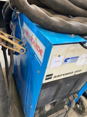 a blue machine with a hose attached to it ' s side