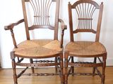 two wooden chairs sitting next to each other on a hard wood floor