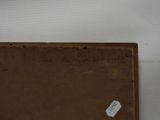 an old book with writing on it sitting on top of a table