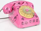 a pink telephone that has a hello kitty design on it