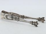 a pair of spoons sitting on top of a white surface