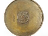 a gold plate with a design on it
