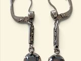 pair of black and white diamond earrings on a white background