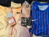 a pile of clothing that is sitting on a bed