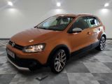 the orange volkswagen crosscauple is parked in the garage