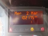 a digital clock on the dashboard of a car