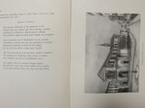 an open book with a drawing of a building in the background