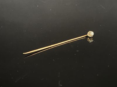 a gold bar with a diamond on it sitting on top of a black surface