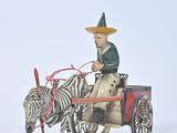 toy figurine of a man riding in a horse drawn carriage with a zebra