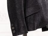 a close up of a suit on a stand