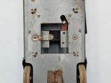 a metal device with wheels attached to it on a wall