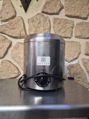 a stainless steel blender sitting on top of a table