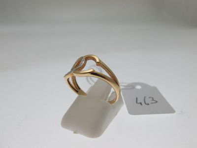 an image of a gold ring on a white surface with a price tag