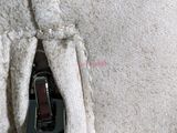 a close up of a zipper on a white blanket