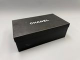 a close up of a black box with a chanel logo on it