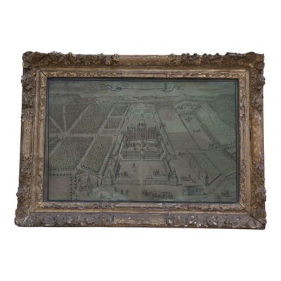 une vieille photo représentant une ville, dans un cadre doré