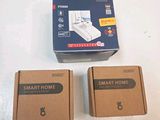 two boxes of smart home products sitting on a table next to each other