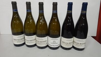 six bottles of wine lined up in a row on a table