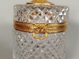 a glass jar with a gold lid on a table
