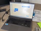 a laptop computer sitting on a desk next to a computer monitor