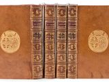 an image of a set of four books with gold medallions on them