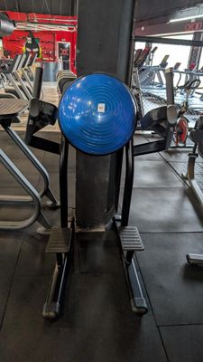a blue ball on a stand in a gym