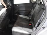 the back seats of a car with a remote control in the passenger seat