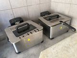 two toasters sitting on a counter in a kitchen