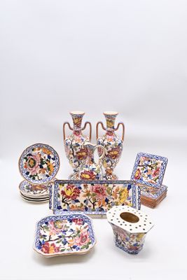 many pieces of pottery that are sitting on a table