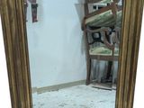a mirror that is sitting on the floor next to a chair