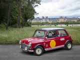 a small red car parked on the side of the road