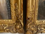 two gold framed pictures of a man and a woman