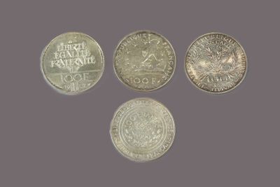 a group of five different coins sitting on top of a table