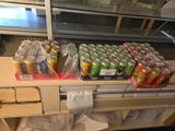 many cans of soda on the counter in the store