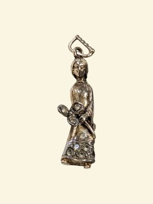 an image of a silver figurine of a woman with a bird on her shoulder