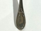 a spoon that is sitting on a white surface