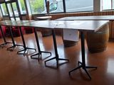 a long table with four chairs in front of a window