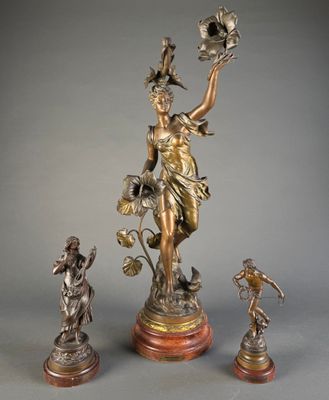 a statue of a woman holding a flower and a bird
